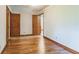 Bedroom featuring gleaming hardwood floors, wood doors, and bright natural light at 5295 Woodland Dr, Lake City, GA 30260