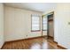 This bedroom features hardwood floors, wallpaper, and a mirrored closet at 5295 Woodland Dr, Lake City, GA 30260
