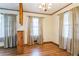Dining room featuring hardwood floors, large windows with curtains, and traditional trim and finishes at 5295 Woodland Dr, Lake City, GA 30260