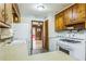 Cozy kitchen featuring wood cabinets and white appliances at 5295 Woodland Dr, Lake City, GA 30260