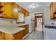The home's kitchen features wooden cabinets, white appliances, and access to other rooms at 5295 Woodland Dr, Lake City, GA 30260