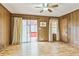 Living room featuring wood paneled walls, and sliding glass doors leading to screened in patio at 5295 Woodland Dr, Lake City, GA 30260