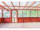 Enclosed porch with wooden floor and screened windows providing a serene view of the backyard at 5295 Woodland Dr, Lake City, GA 30260