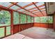 Large screened-in porch with clear roof panels allowing natural light and a view of the backyard at 5295 Woodland Dr, Lake City, GA 30260