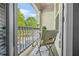 Relaxing outdoor balcony with seating, offering a view of the surrounding landscape and neighborhood at 7691 Cabrini Pl, Fairburn, GA 30213