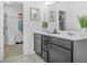 Bathroom with double vanity, modern cabinetry, and a walk-in closet at 7691 Cabrini Pl, Fairburn, GA 30213