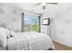 Comfortable bedroom featuring neutral colors, a ceiling fan, and natural light from the window at 7691 Cabrini Pl, Fairburn, GA 30213