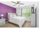 Bright bedroom with a comfortable bed, a ceiling fan, and natural light from the window at 7691 Cabrini Pl, Fairburn, GA 30213