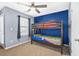 bedroom featuring a bunk bed set, neutral colors, and natural light from the window at 7691 Cabrini Pl, Fairburn, GA 30213