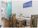 Cozy dining room features a wooden table set for four with direct access to a half bathroom at 7691 Cabrini Pl, Fairburn, GA 30213