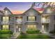 Charming townhome featuring brick facade, upper balconies, manicured lawn, and inviting entrance at 7691 Cabrini Pl, Fairburn, GA 30213