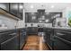 A modern kitchen features stainless steel appliances, grey cabinets and granite countertops at 7691 Cabrini Pl, Fairburn, GA 30213
