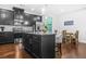 Modern kitchen boasts stainless steel appliances, a kitchen island, and stylish bar stools at 7691 Cabrini Pl, Fairburn, GA 30213