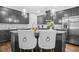 Modern kitchen featuring stainless steel appliances, gray cabinets, granite countertops, and stylish pendant lighting at 7691 Cabrini Pl, Fairburn, GA 30213