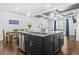 Open-concept kitchen with a large granite island, stainless steel appliances, and a coffered ceiling at 7691 Cabrini Pl, Fairburn, GA 30213