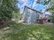 Wide backyard with a wooden deck and stairs leading to the house's back entrance at 907 Fox Croft Pl, Canton, GA 30114