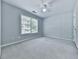 The bedroom offers a ceiling fan, a window, plush carpet and an accent wall at 907 Fox Croft Pl, Canton, GA 30114