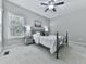 This bedroom features a ceiling fan, a large window, and carpeted floors at 907 Fox Croft Pl, Canton, GA 30114