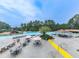 An aerial view of a large community pool with tables, seating, and water park features at 907 Fox Croft Pl, Canton, GA 30114