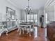 Elegant dining room with hardwood floors, a chandelier, a buffet, and a large window with natural light at 907 Fox Croft Pl, Canton, GA 30114