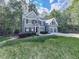 Well-maintained two-story home with lush front lawn, a long driveway, a 2-car garage, and lovely landscaping at 907 Fox Croft Pl, Canton, GA 30114