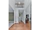 Foyer featuring hardwood floors, natural light, a view of the living space, and a decorative stairway at 907 Fox Croft Pl, Canton, GA 30114