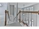 Second floor hallway with wooden rails and a view to the living room downstairs at 907 Fox Croft Pl, Canton, GA 30114