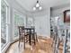 Sunlit kitchen features a breakfast nook with wooded views and hardwood floors at 907 Fox Croft Pl, Canton, GA 30114