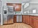 Kitchen features stainless steel appliances, cherry cabinets, and hardwood floors at 907 Fox Croft Pl, Canton, GA 30114