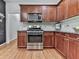 Kitchen features stainless steel appliances, cherry cabinets, and hardwood floors at 907 Fox Croft Pl, Canton, GA 30114