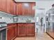 The kitchen has cherry cabinets, stainless steel appliances and granite countertops at 907 Fox Croft Pl, Canton, GA 30114