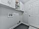 Neat laundry room with white cabinets, washer/dryer hookups, and a door to the outside at 907 Fox Croft Pl, Canton, GA 30114