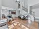 Bright living room features hardwood floors, a ceiling fan, and a staircase at 907 Fox Croft Pl, Canton, GA 30114