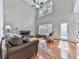 Bright living room with hardwood floors, high ceilings, many windows letting in natural light, and a stone fireplace at 907 Fox Croft Pl, Canton, GA 30114
