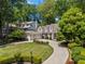 Aerial view of a home with manicured lawns, a large driveway and a two-car garage at 998 Ferncliff Ne Rd, Atlanta, GA 30324