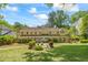 Expansive backyard featuring lush lawn, mature trees, and a stone patio with comfortable seating at 998 Ferncliff Ne Rd, Atlanta, GA 30324