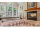 Spacious bathroom features soaking tub, fireplace, shelving, and windows with a view at 998 Ferncliff Ne Rd, Atlanta, GA 30324