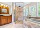Updated bathroom with glass shower, soaking tub, and custom vanity with wood cabinets at 998 Ferncliff Ne Rd, Atlanta, GA 30324