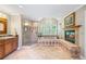 Luxurious bathroom featuring a soaking tub, walk-in shower, fireplace and custom vanity at 998 Ferncliff Ne Rd, Atlanta, GA 30324