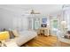Bright bedroom with wood floors, large windows, and a vanity/desk area, creating an inviting space at 998 Ferncliff Ne Rd, Atlanta, GA 30324
