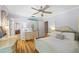 Cozy bedroom with hardwood floors, a ceiling fan, and natural light streaming through the windows at 998 Ferncliff Ne Rd, Atlanta, GA 30324