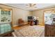 Bright bedroom featuring hardwood floors, neutral walls, and large windows with decorative curtains at 998 Ferncliff Ne Rd, Atlanta, GA 30324