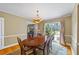 Bright dining room featuring a wood table, chairs, chandelier, and large windows at 998 Ferncliff Ne Rd, Atlanta, GA 30324