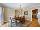 Dining room with hardwood floors, wood table with chairs, and view into the kitchen at 998 Ferncliff Ne Rd, Atlanta, GA 30324