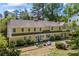 Large home exterior with a well-manicured lawn, patio seating, and mature landscaping at 998 Ferncliff Ne Rd, Atlanta, GA 30324
