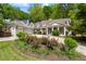 Charming home featuring a meticulously manicured lawn, flower garden, and inviting columned front porch at 998 Ferncliff Ne Rd, Atlanta, GA 30324