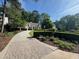 A paved driveway leads to a charming home with a well-manicured lawn and lush greenery at 998 Ferncliff Ne Rd, Atlanta, GA 30324