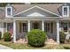 Inviting front porch features columns, brick steps, an American flag, and manicured greenery at 998 Ferncliff Ne Rd, Atlanta, GA 30324