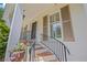 Close-up of front porch features brick steps with black metal railing and painted brick exterior at 998 Ferncliff Ne Rd, Atlanta, GA 30324