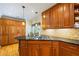 Kitchen island featuring a cooktop, black granite counters and ample cabinet space at 998 Ferncliff Ne Rd, Atlanta, GA 30324
